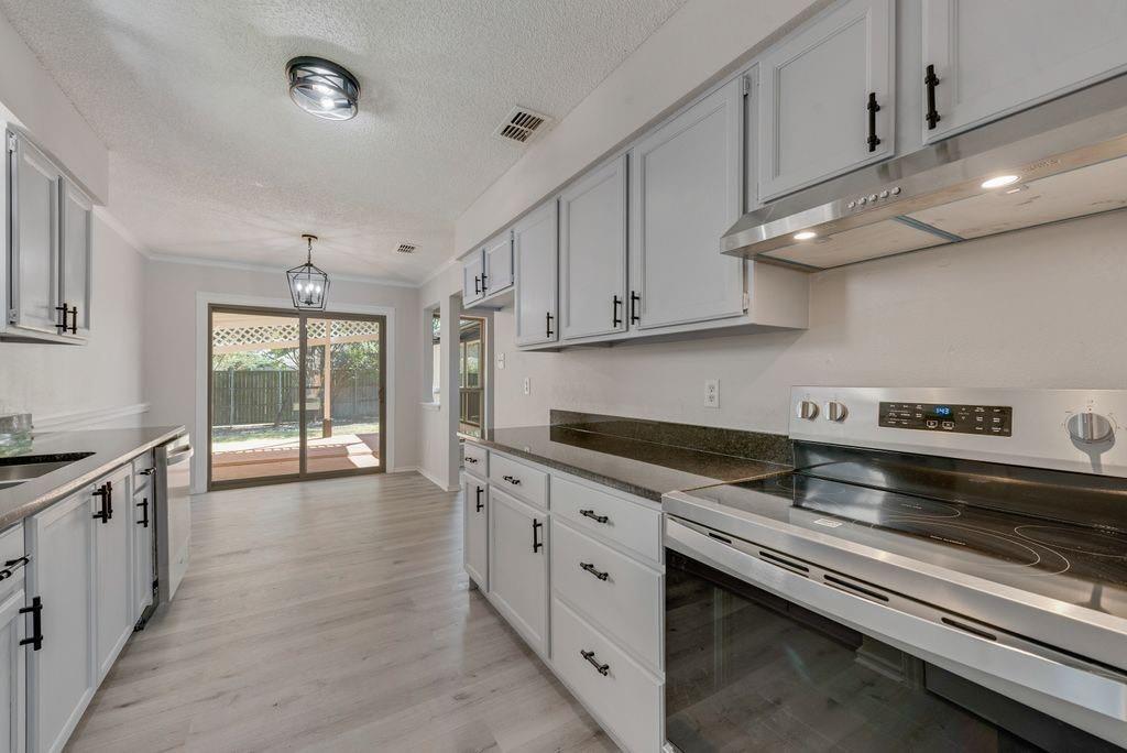 3510 Jonquil Lane Rowlett, TX 75089 - Photo 17 of 35 a kitchen with stainless steel appliances granite countertop a sink and a stove
