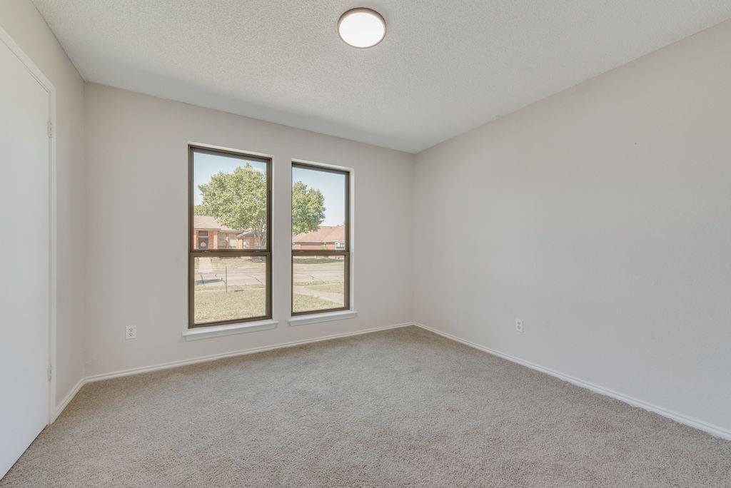 3510 Jonquil Lane Rowlett, TX 75089 - Photo 19 of 35 an empty room with windows