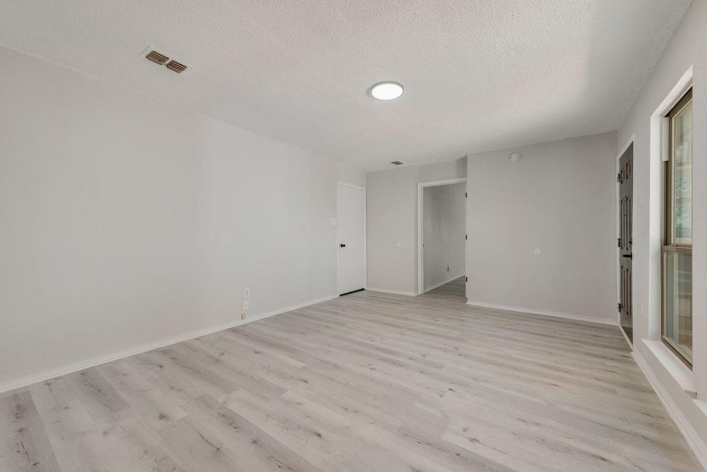 3510 Jonquil Lane Rowlett, TX 75089 - Photo 28 of 35 a view of an empty room with wooden floor and a window