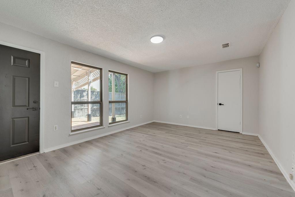 3510 Jonquil Lane Rowlett, TX 75089 - Photo 29 of 35 a view of an empty room with wooden floor and a window
