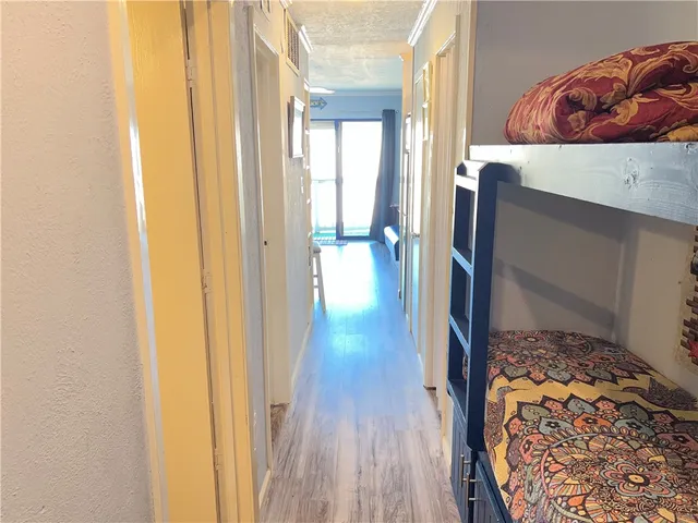a view of walk in closet with wooden floor