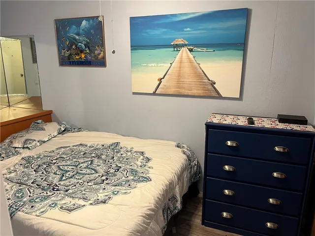 a bedroom with a bed and a dresser