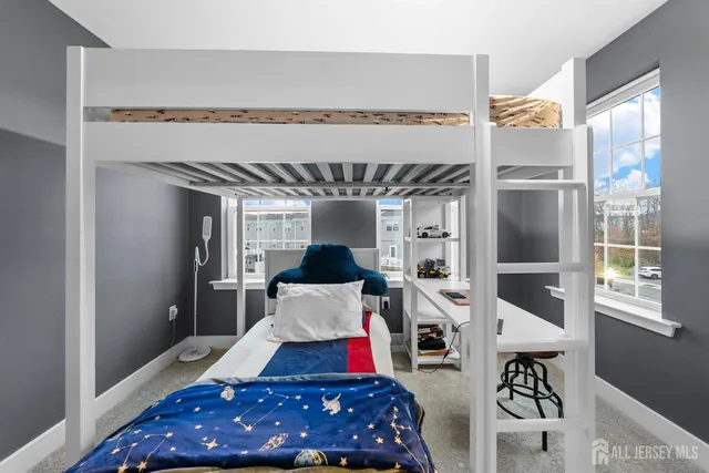 a living room with furniture and large windows