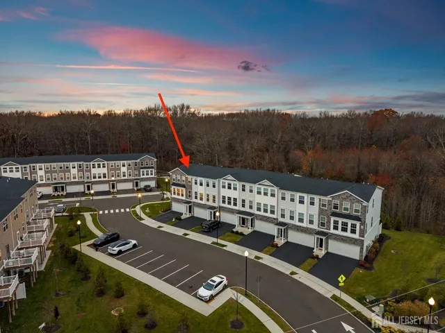 a view of kitchen with stainless steel appliances refrigerator stove microwave and cabinets