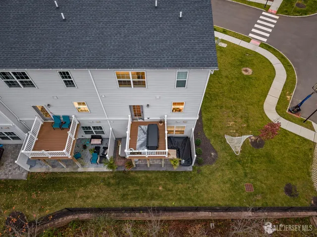 a view of a hallway with stairs and wooden floor