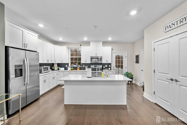 a kitchen with refrigerator and cabinets