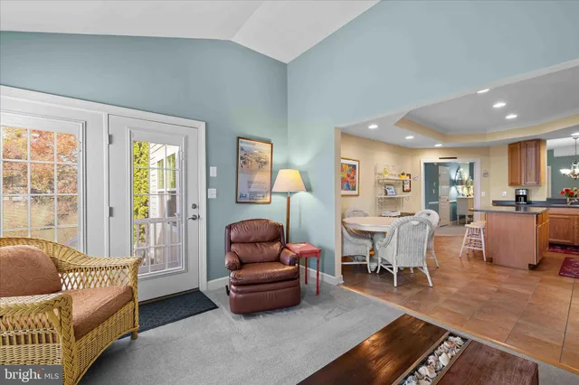 a bedroom with a bed a table and large window