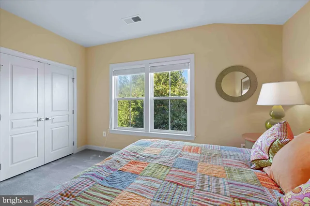 a bed room with a bed and a chair