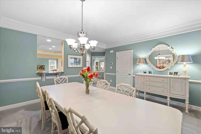 a view of a dining room with furniture and chandelier