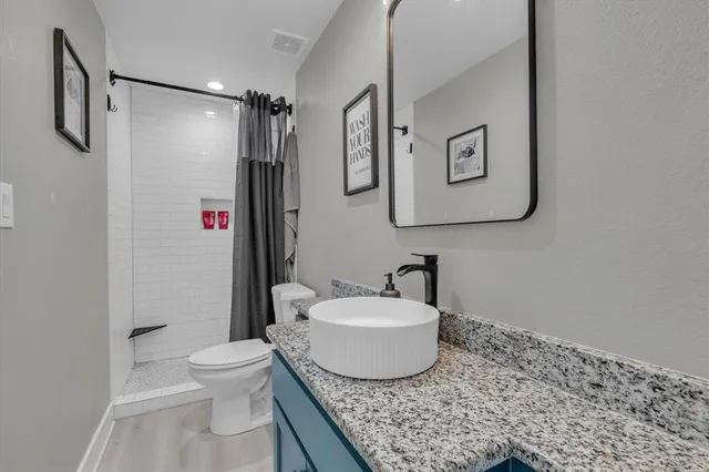 a bedroom with a bed dresser and a window