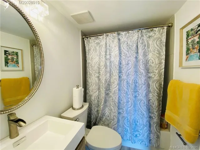 a kitchen with white cabinets and sink