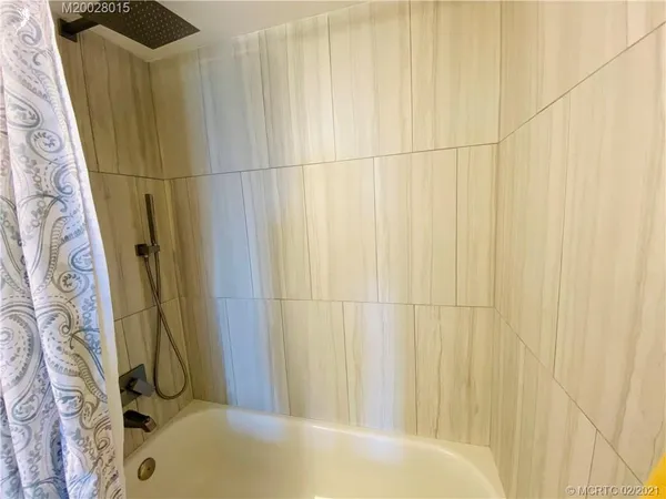 a kitchen with white cabinets and sink