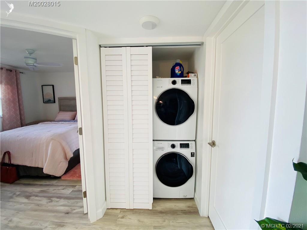 7440 South Ocean Drive, Unit 524A Jensen Beach, FL 34957 - Photo 13 of 64 a view of a bedroom with washer and dryer
