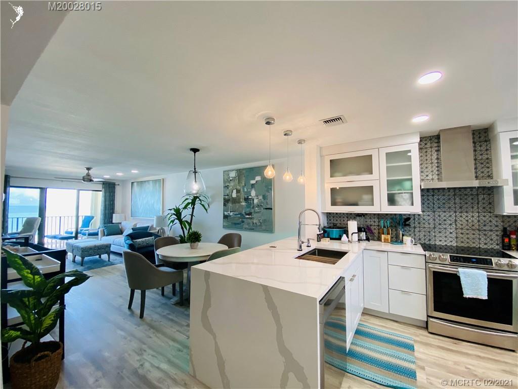 7440 South Ocean Drive, Unit 524A Jensen Beach, FL 34957 - Photo 14 of 64 a kitchen that has a lot of cabinets a sink and appliances in it