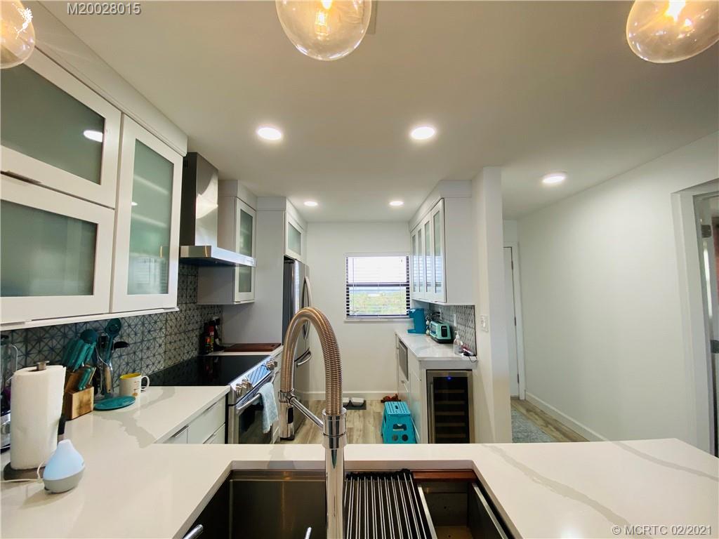7440 South Ocean Drive, Unit 524A Jensen Beach, FL 34957 - Photo 20 of 64 a kitchen with white cabinets and sink