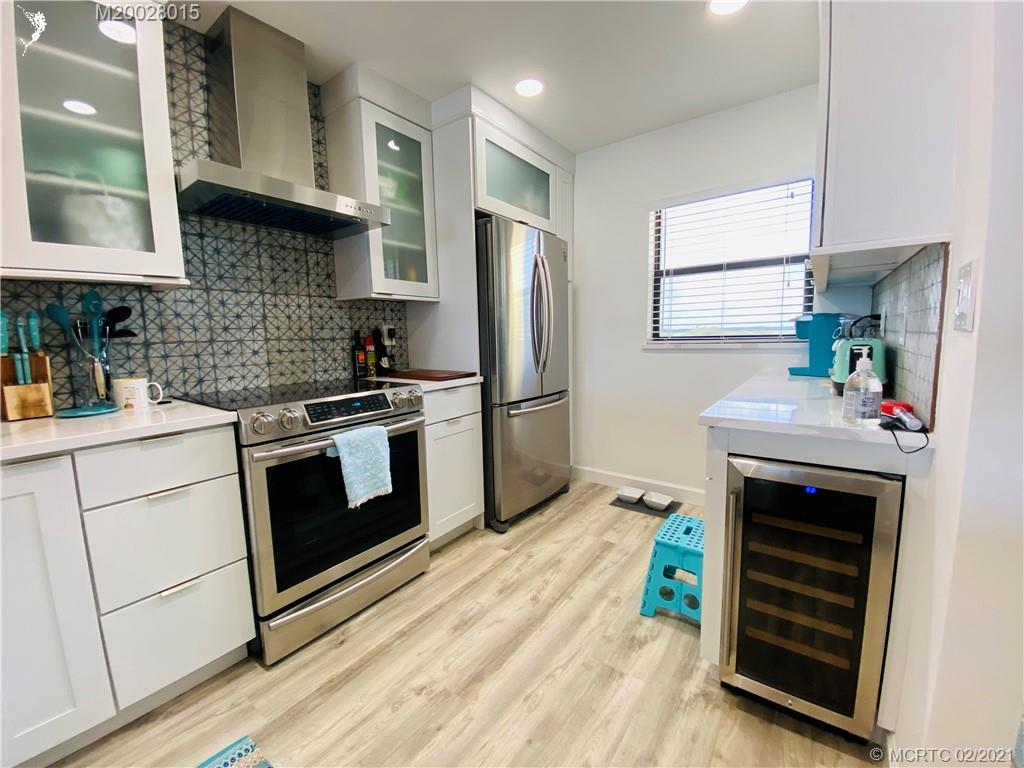 7440 South Ocean Drive, Unit 524A Jensen Beach, FL 34957 - Photo 21 of 64 a kitchen with granite countertop a stove and a sink