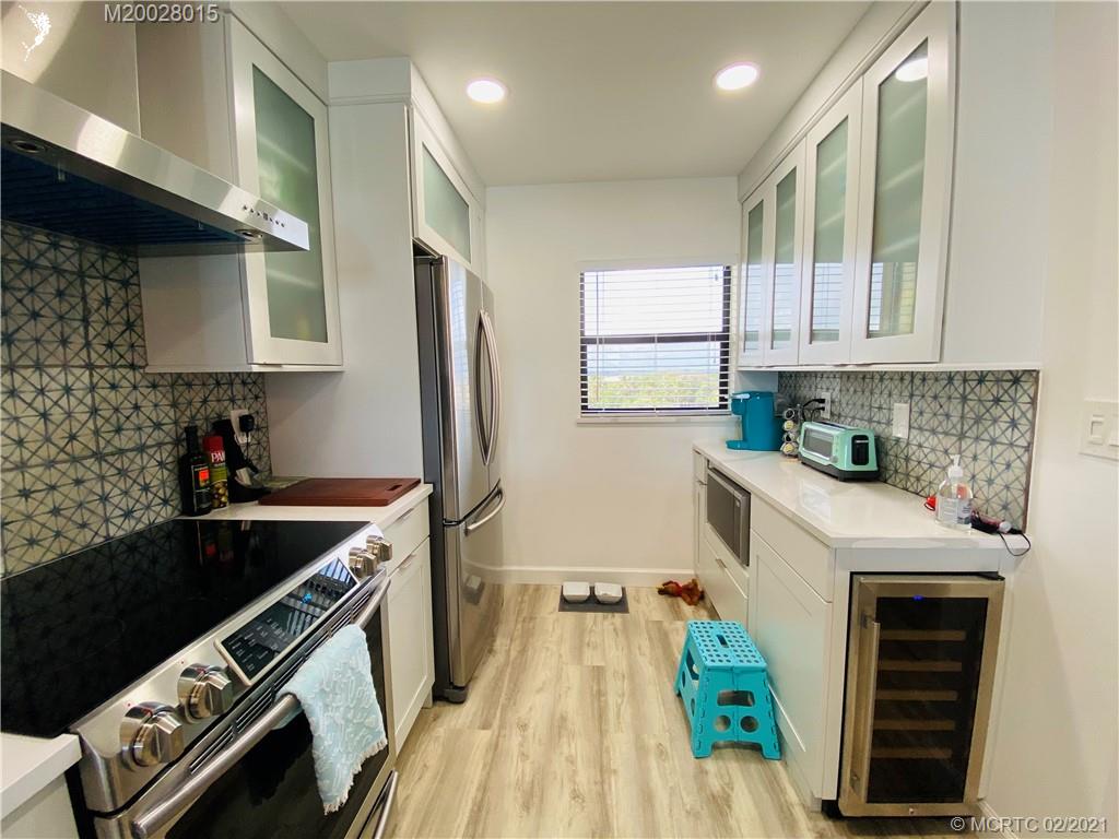 7440 South Ocean Drive, Unit 524A Jensen Beach, FL 34957 - Photo 22 of 64 a kitchen with a sink appliances cabinets and a window