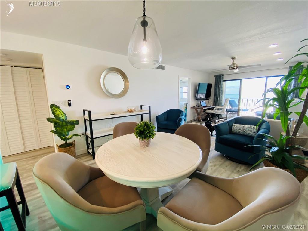 7440 South Ocean Drive, Unit 524A Jensen Beach, FL 34957 - Photo 25 of 64 a living room with furniture a chandelier and a potted plant