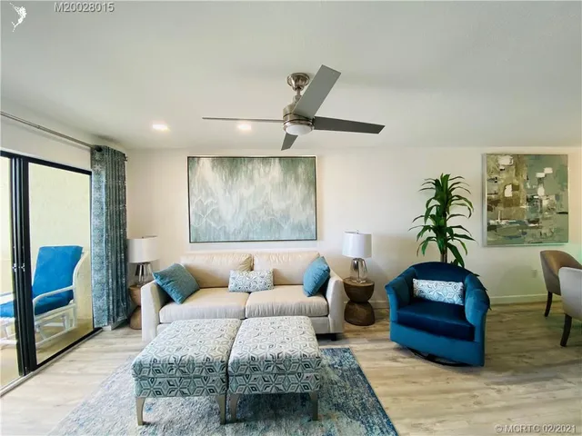 a bedroom with a bed and a potted plant