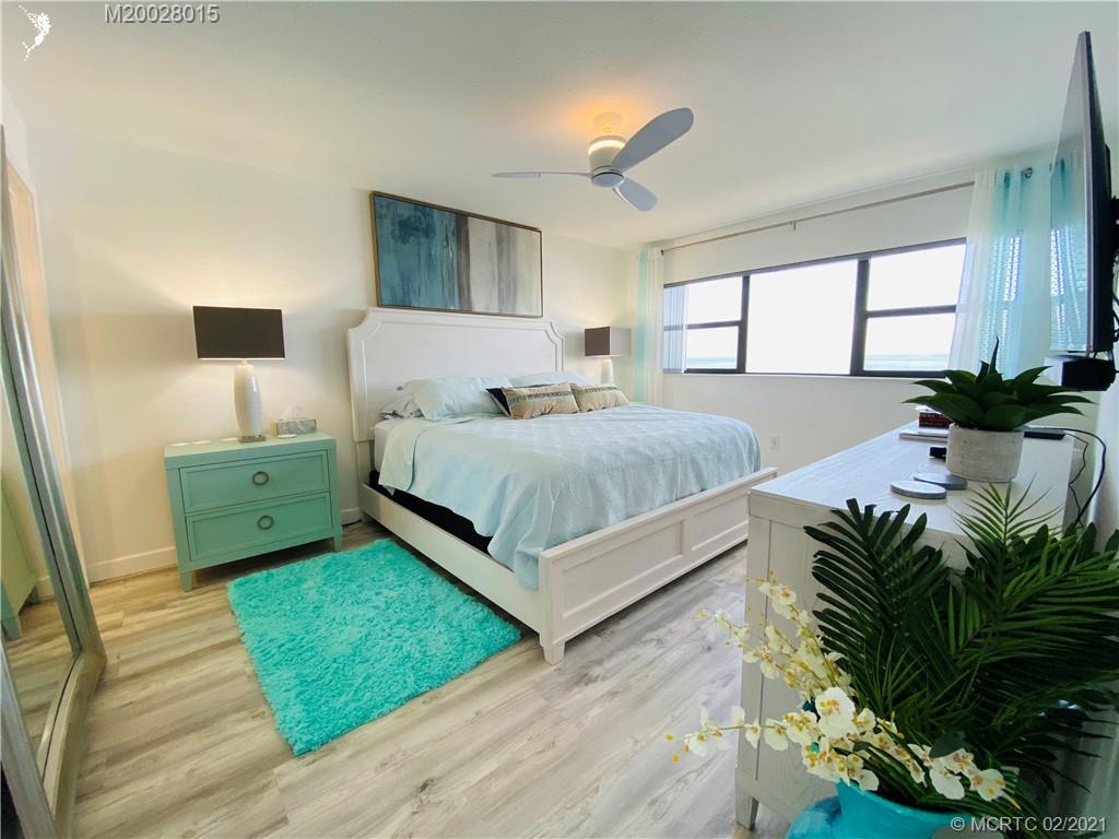 7440 South Ocean Drive, Unit 524A Jensen Beach, FL 34957 - Photo 39 of 64 a bedroom with a bed and a potted plant