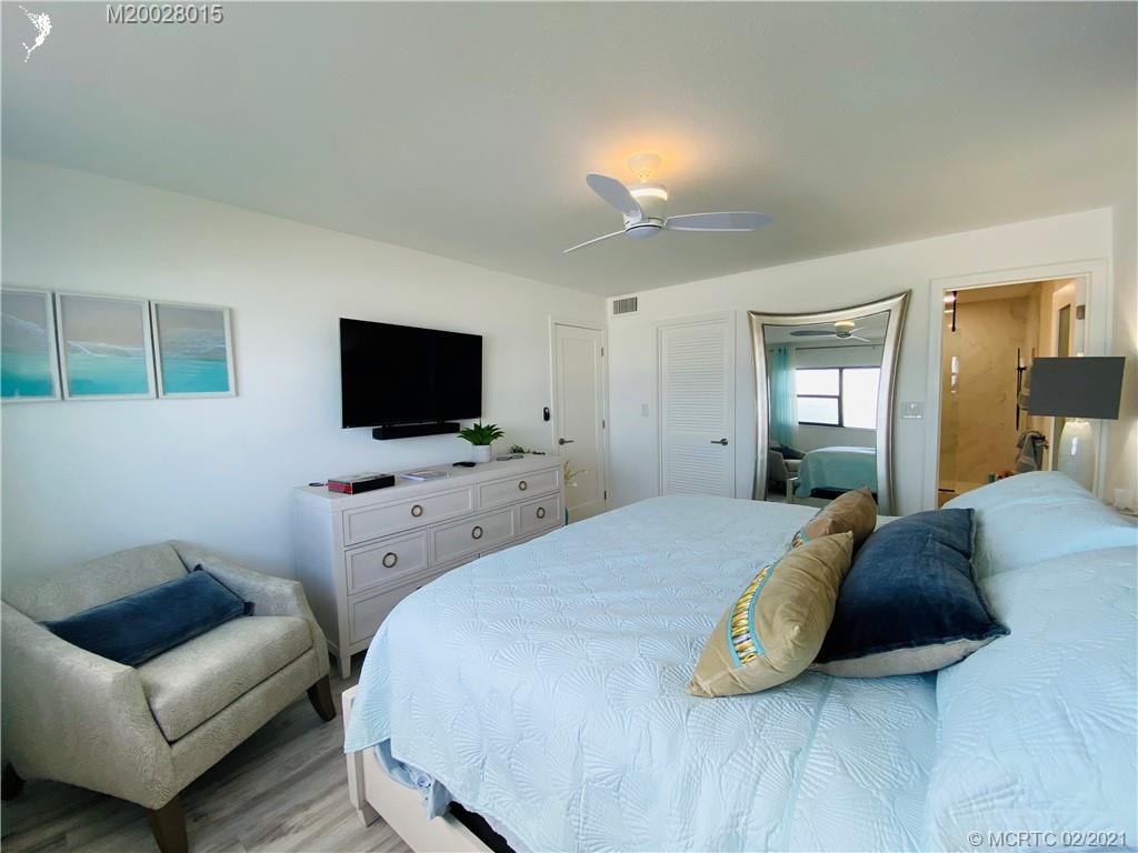 7440 South Ocean Drive, Unit 524A Jensen Beach, FL 34957 - Photo 43 of 64 a bedroom with a bed and a flat screen tv