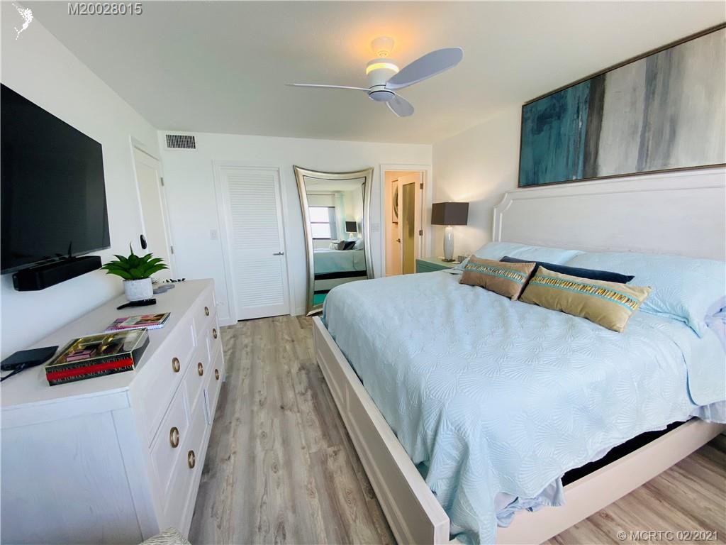 7440 South Ocean Drive, Unit 524A Jensen Beach, FL 34957 - Photo 44 of 64 a bedroom with a bed and a flat screen tv