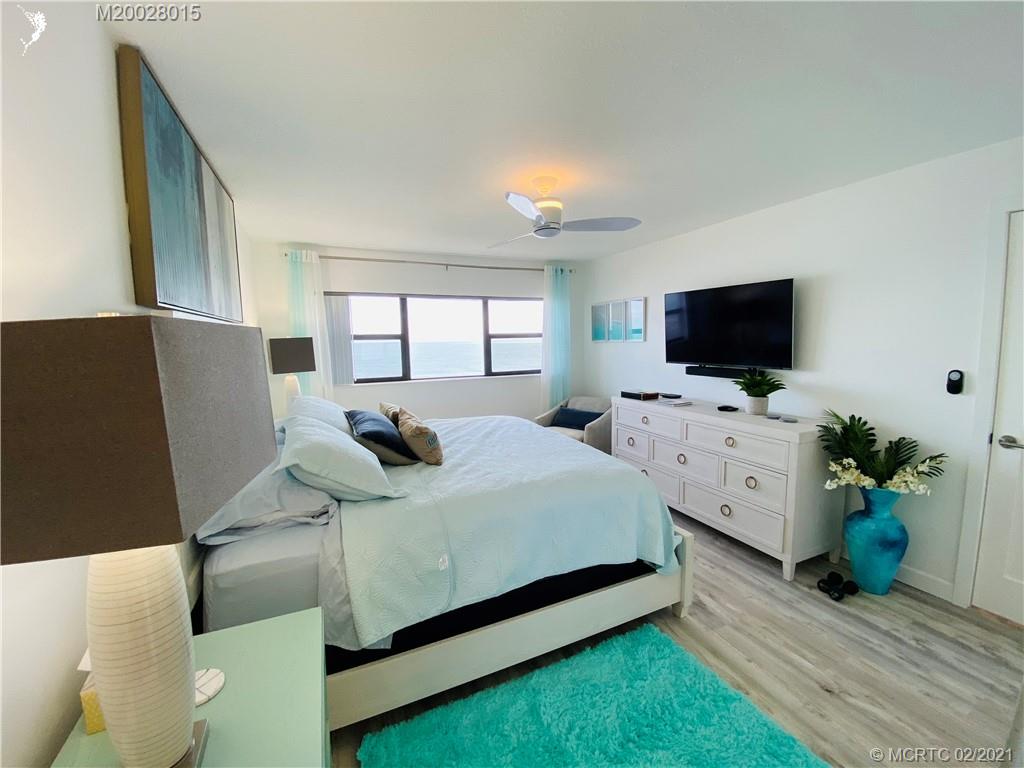 7440 South Ocean Drive, Unit 524A Jensen Beach, FL 34957 - Photo 45 of 64 a bed room with two bed window and a flat screen tv