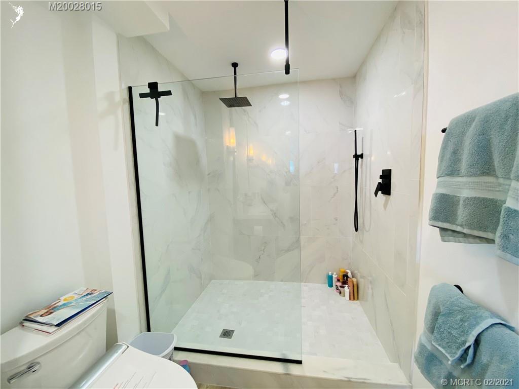 7440 South Ocean Drive, Unit 524A Jensen Beach, FL 34957 - Photo 47 of 64 a bathroom with a tub a toilet and a shower