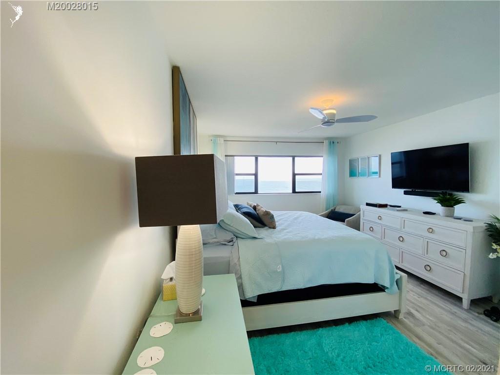 7440 South Ocean Drive, Unit 524A Jensen Beach, FL 34957 - Photo 50 of 64 a bedroom with bed and flat tv screen on dresser