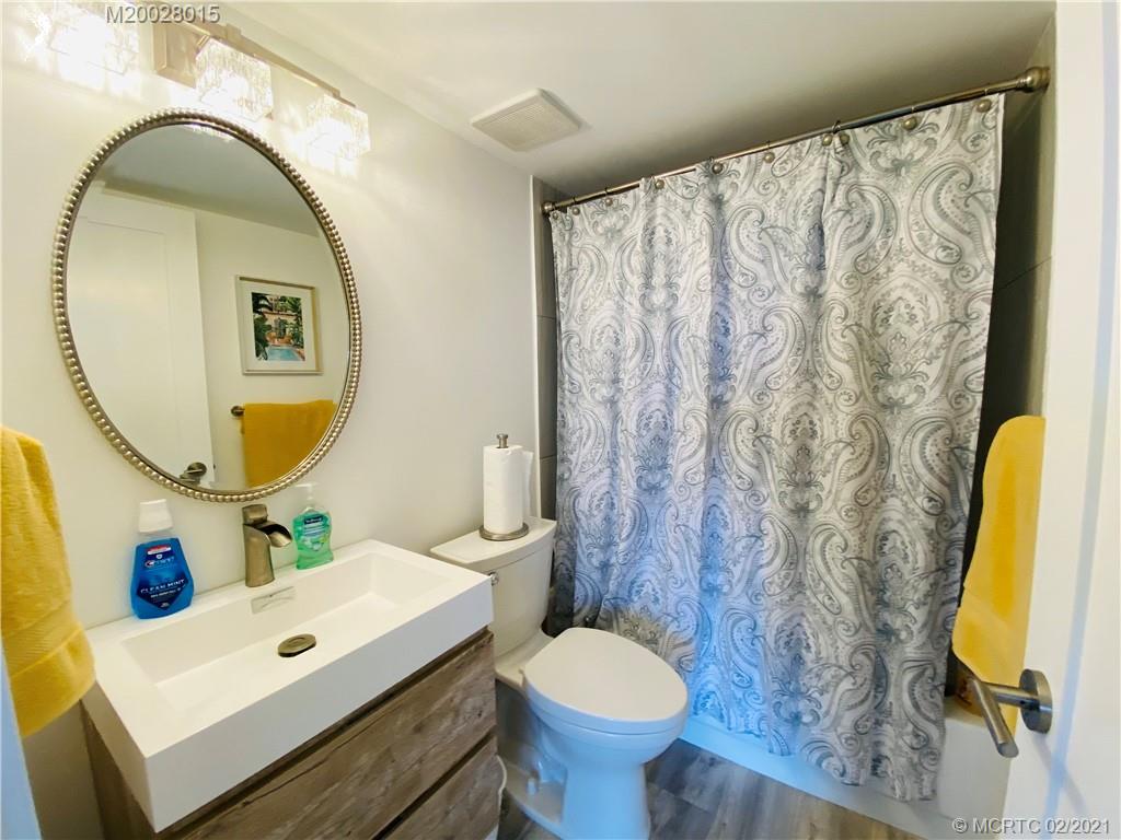 7440 South Ocean Drive, Unit 524A Jensen Beach, FL 34957 - Photo 10 of 64 a bathroom with a toilet sink and mirror
