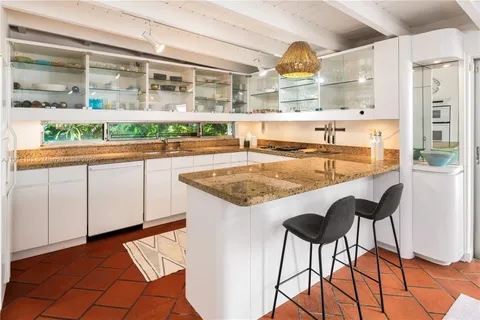 a kitchen with stainless steel appliances granite countertop a stove and a refrigerator
