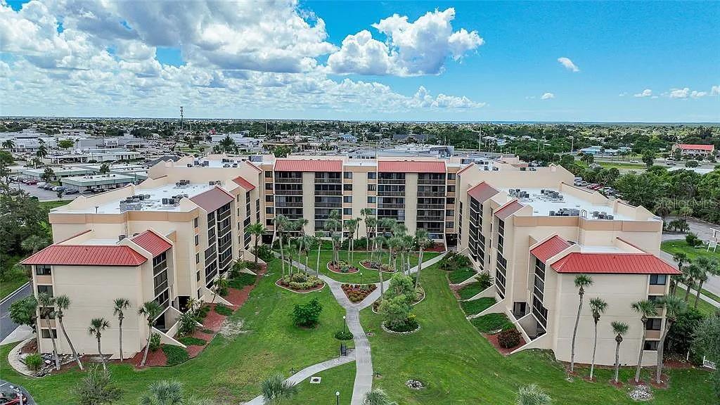 3006 Caring Way, Unit 329 Port Charlotte, FL 33952 - Photo 1 of 37 an aerial view of a house with a yard