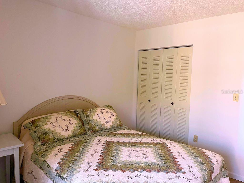 3006 Caring Way, Unit 329 Port Charlotte, FL 33952 - Photo 15 of 37 a bedroom with a bed and a window