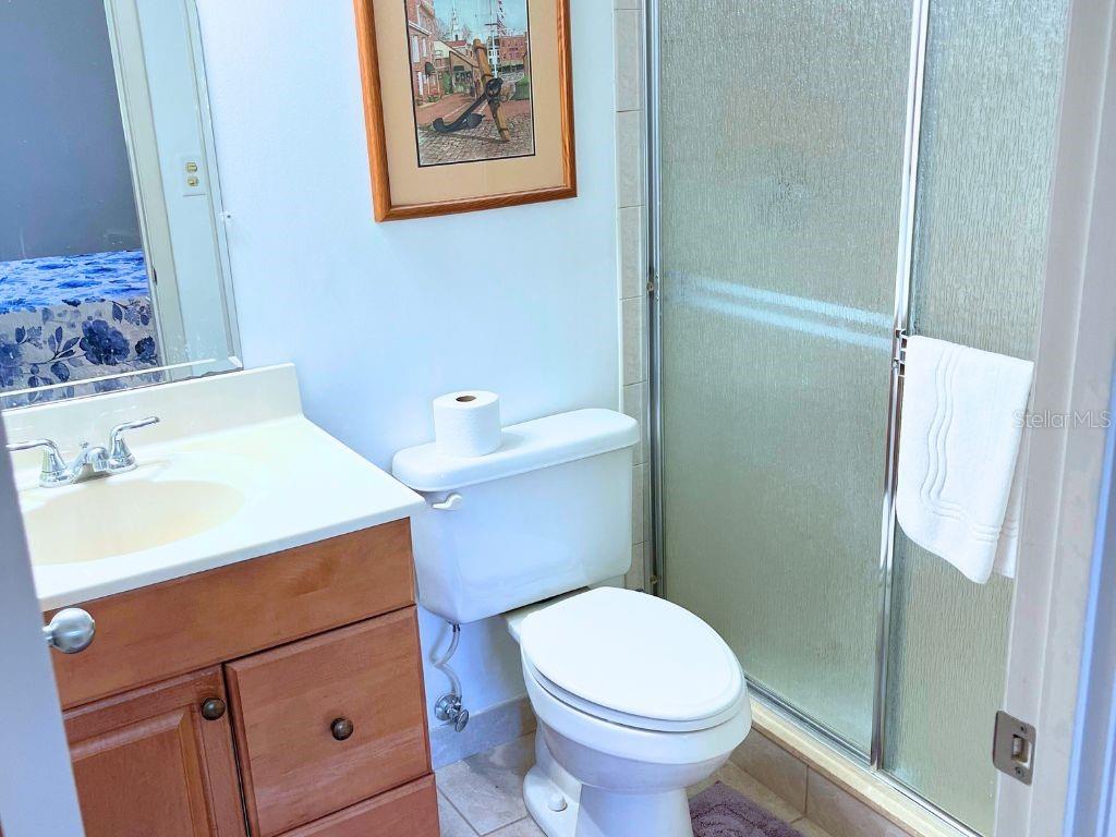 3006 Caring Way, Unit 329 Port Charlotte, FL 33952 - Photo 16 of 37 a bathroom with a sink a toilet and shower