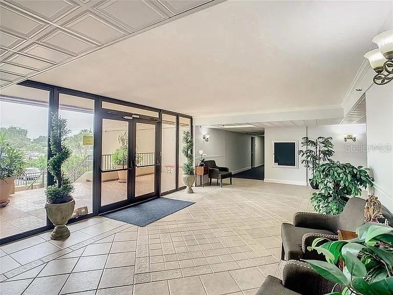 3006 Caring Way, Unit 329 Port Charlotte, FL 33952 - Photo 30 of 37 a living room with furniture and a large window