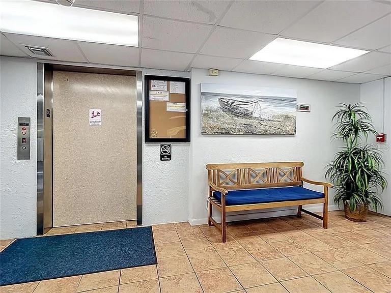 3006 Caring Way, Unit 329 Port Charlotte, FL 33952 - Photo 34 of 37 a blue bench sitting in front of a door