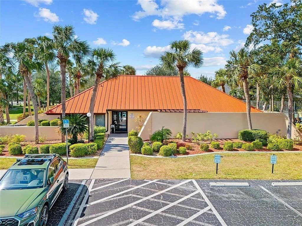 3006 Caring Way, Unit 329 Port Charlotte, FL 33952 - Photo 36 of 37 a view of a swimming pool with a patio and a garden