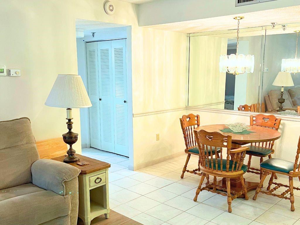 3006 Caring Way, Unit 329 Port Charlotte, FL 33952 - Photo 4 of 37 a living room with a table and a lamp