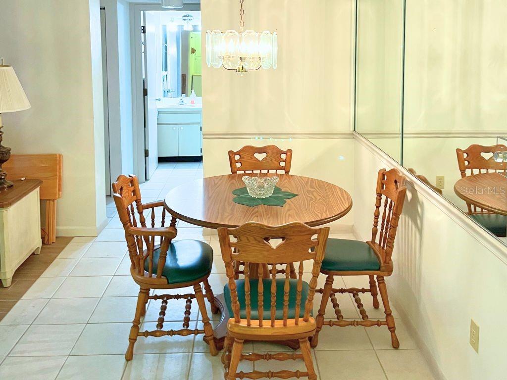 3006 Caring Way, Unit 329 Port Charlotte, FL 33952 - Photo 5 of 37 a dining room with furniture and wooden floor