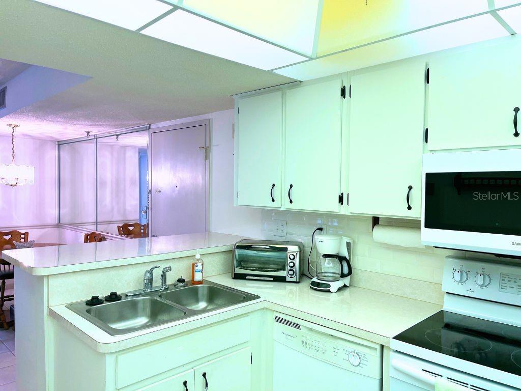 3006 Caring Way, Unit 329 Port Charlotte, FL 33952 - Photo 9 of 37 a kitchen with a sink cabinets and window