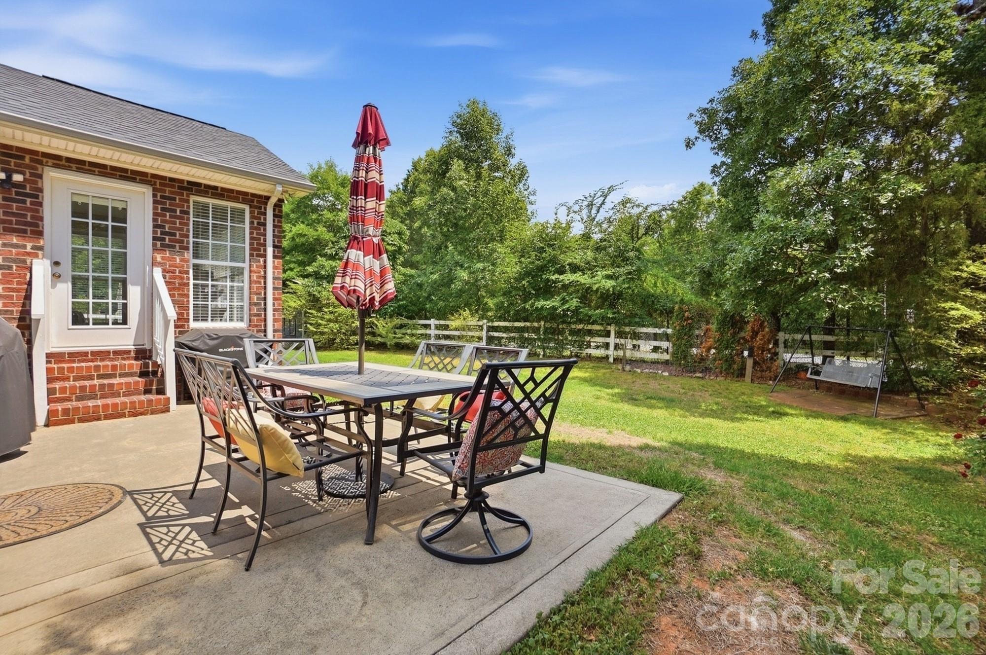 3324 Muddy Creek Road Midland, NC 28107 - Photo 41 of 46 a view of a backyard with table and chairs and potted plants
