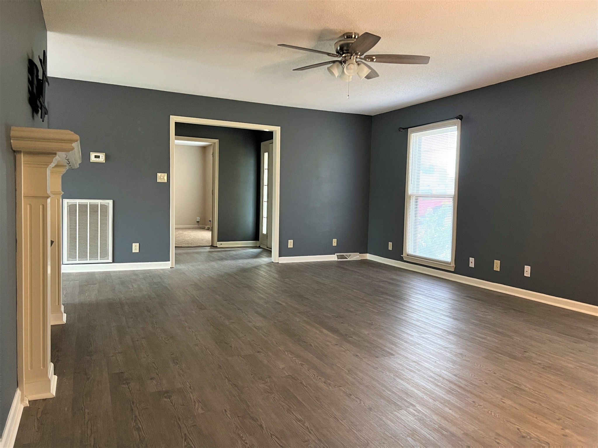 153 Old Farmers Road Clarksville, TN 37043 - Photo 5 of 23 a view of a livingroom with wooden floor and a ceiling fan