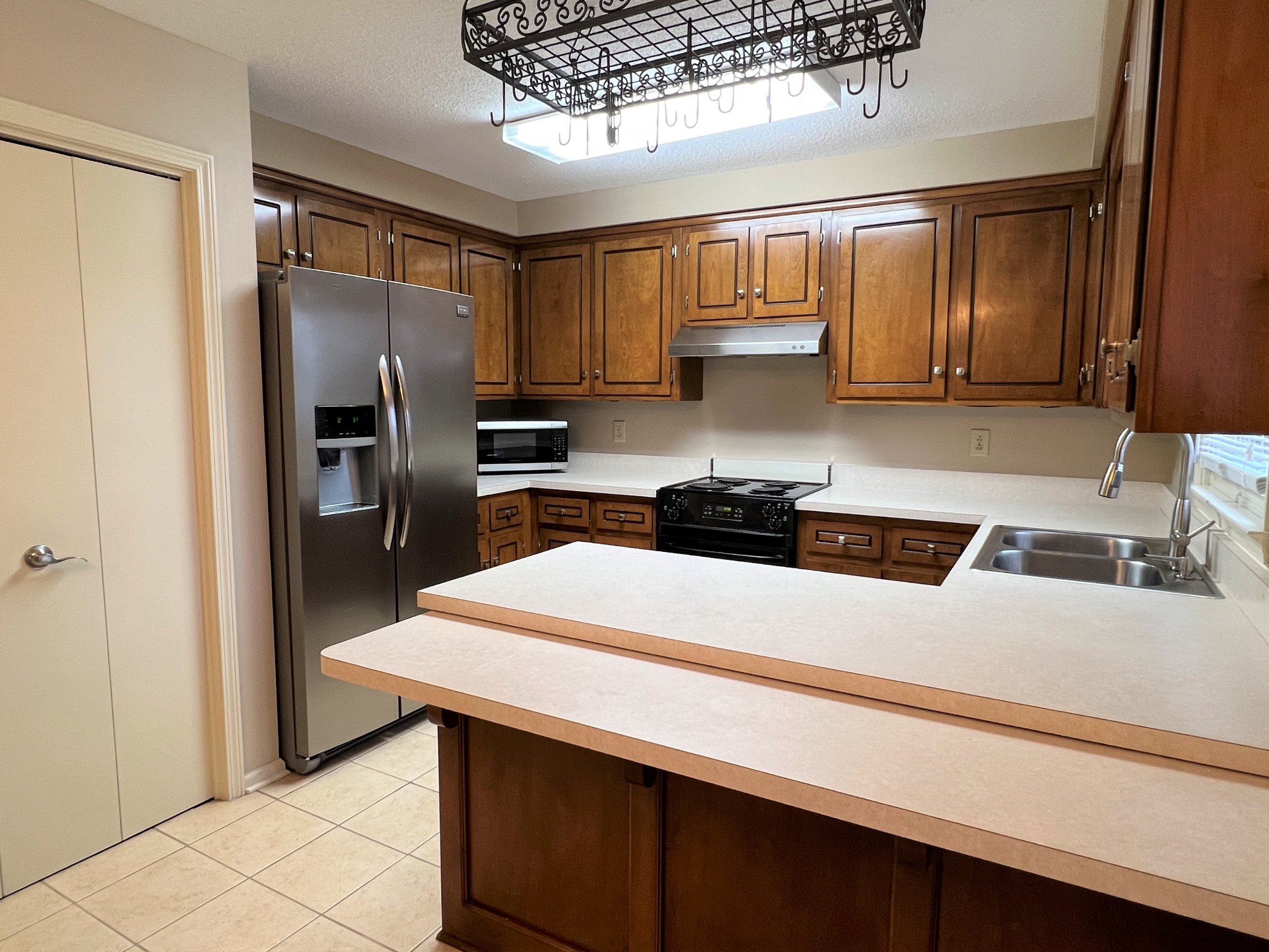 153 Old Farmers Road Clarksville, TN 37043 - Photo 6 of 23 a kitchen with stainless steel appliances a refrigerator sink and cabinets