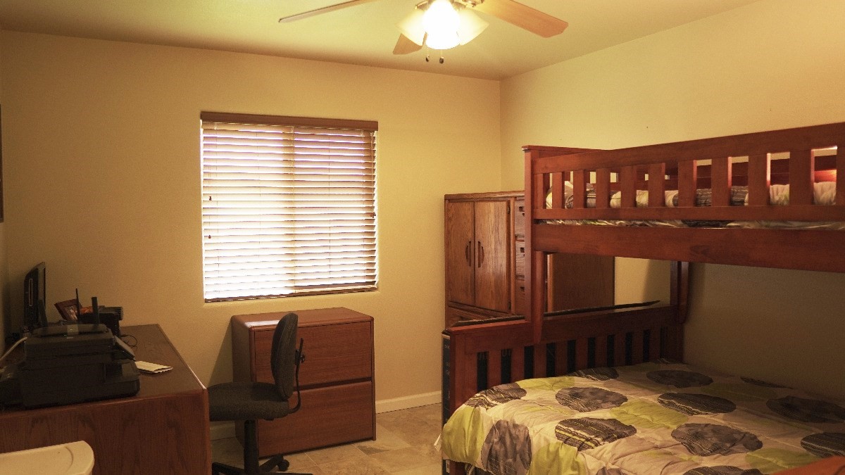 14-521 Hapuu Road Pahoa, HI 96778 - Photo 8 of 13 a bedroom with a bed and wooden floor