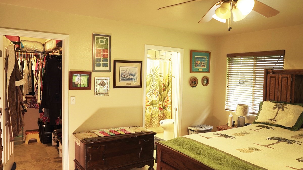 14-521 Hapuu Road Pahoa, HI 96778 - Photo 9 of 13 a bedroom with a bed and a chandelier