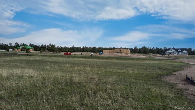 a view of a lake with houses in back