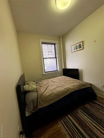 a bedroom with a bed and window