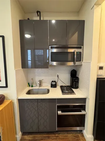 a kitchen with a sink and cabinets