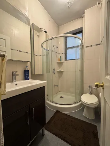 a bathroom with a sink toilet a mirror and shower