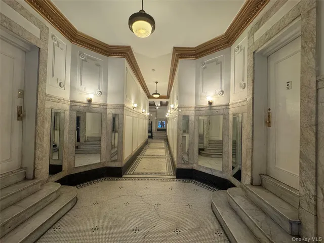 a view of a hallway with wooden floor and door